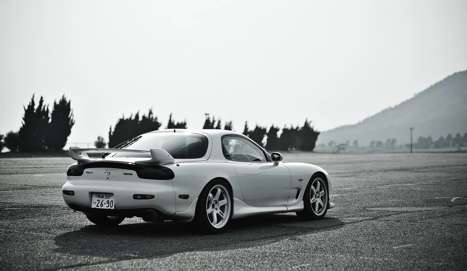 White Mazda RX-7 in an open landscape, editorial photograph supplied by the owner
